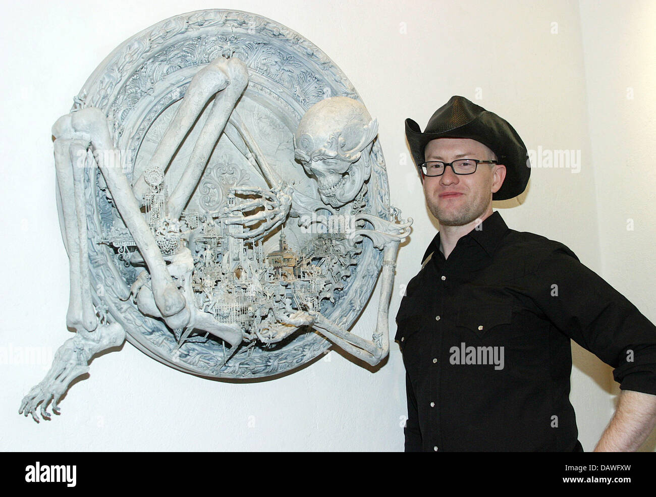 US artist Kris Kuksi pictured with oine of his works at the Strychnin Gallery in Berlin, Germany, 13 April 2007. He presents his works ranging in price from 2,500 to 5,500 euro under the theme 'Lost Worlds'. Photo: Xamax Stock Photo
