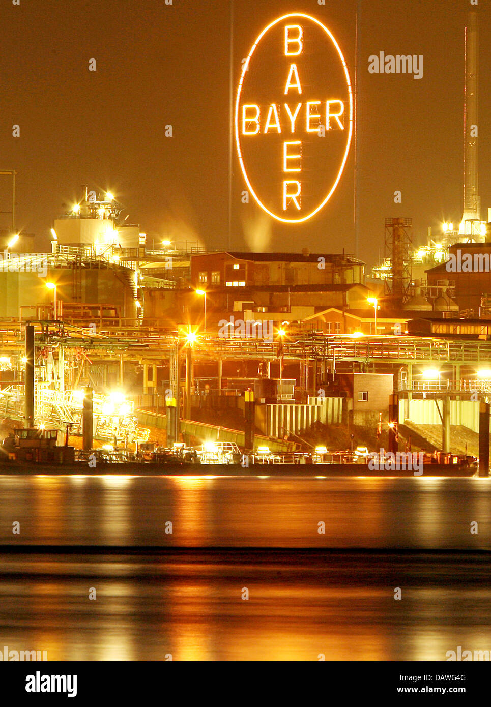 The lights of the Bayer main plant reflect in the river Rhine in