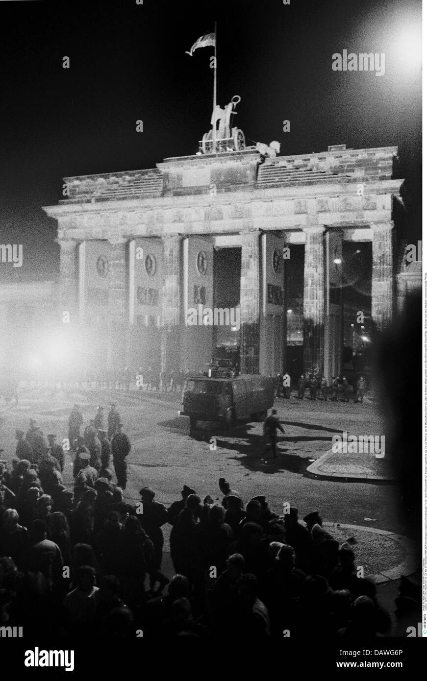 geography / travel, Germany, reunification, Berlin, Berlin Wall, GDR border troops controlling the Brandenburg Gate with watercannon cars, night shot, 10. / 11.11.1989, East Germany, historic, historical, East-Germany, 20th century, 1980s, 80s, Pariser Platz, Brandenburger Tor, square, celebration, people, celebrating, 24 hours after the fall, down, opening, turn of events, history, freedom, crossing, November'89, November 89, border patrol, Additional-Rights-Clearences-Not Available Stock Photo