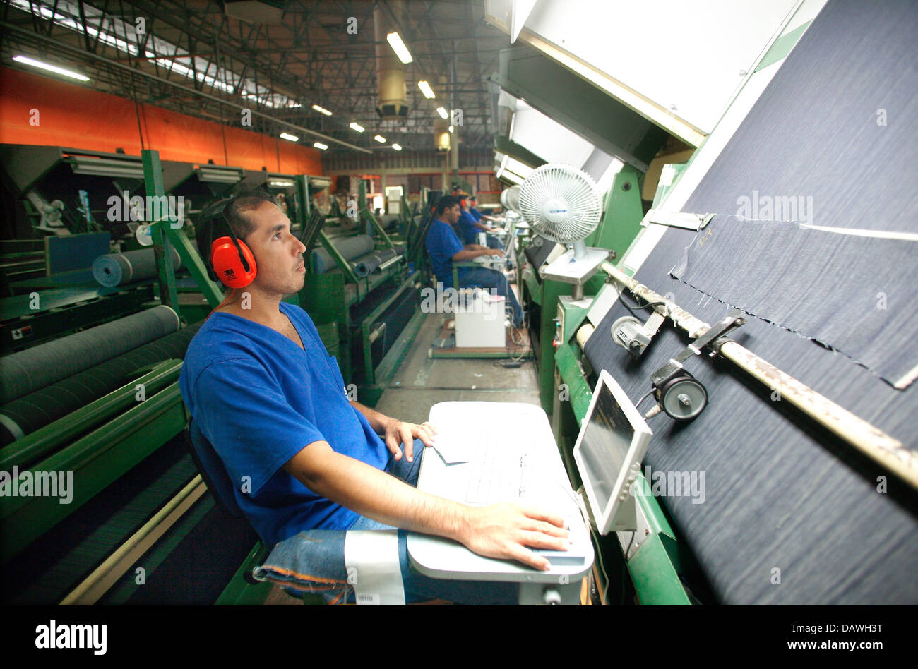 Workers operate machines at the Jeans factory Santana in Fortaleza, Brazil, 11 April 2007. Photo: Soeren Stache Stock Photo
