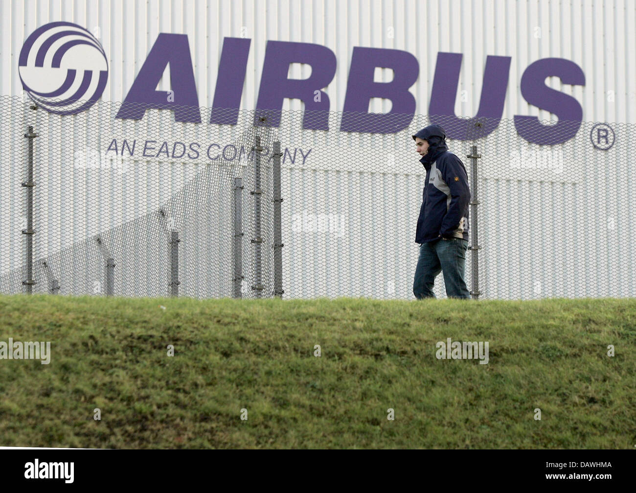 (dpa file) A man walks past the Airbus plant Nordenham, Germany, 06 February 2006. Photo: Ingo Wagner Stock Photo