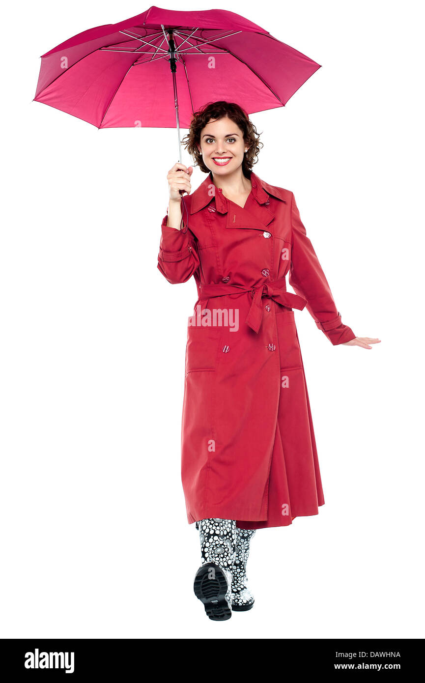Gorgeous lady with umbrella walking towards you Stock Photo - Alamy