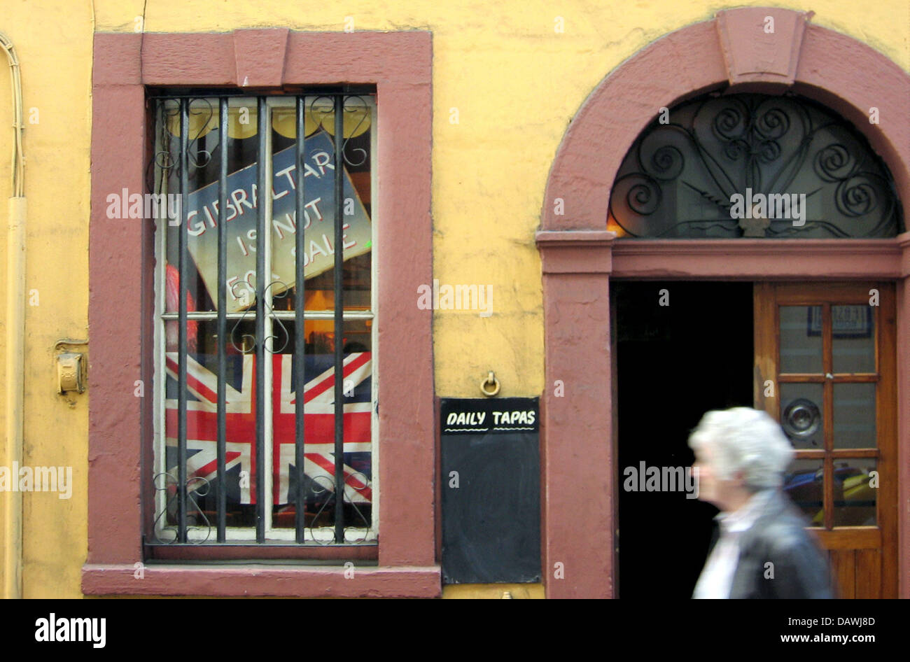 A sign reading 'Gibraltar is nor for sale' is pictured at a window of a
