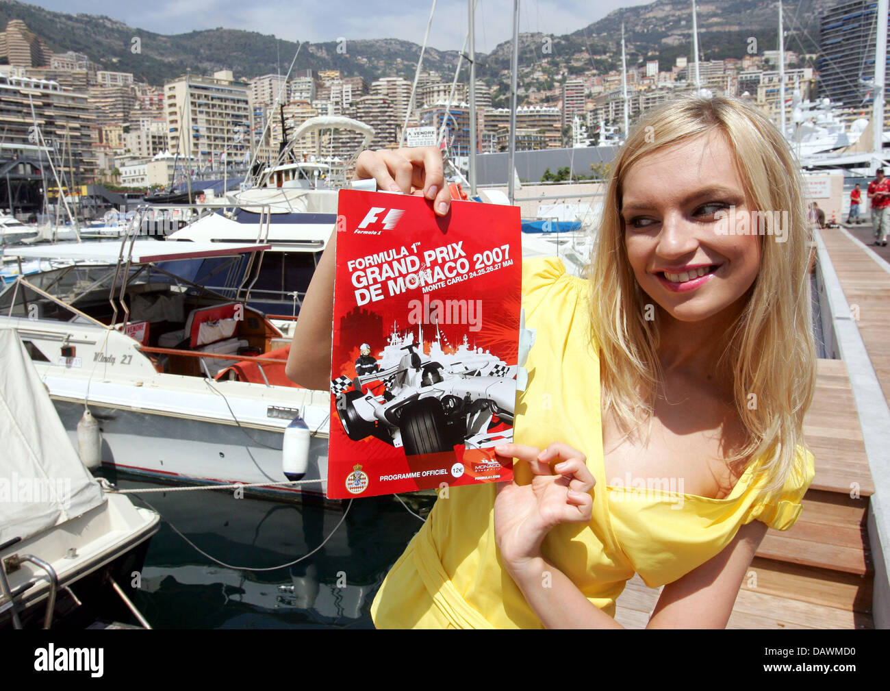 A model presents a race programme in front of the harbour in Monte Carlo, Monaco, Wednesday, 23 May 2007. The Monaco Grand Prix takes place on Sunday, 27 May 2007. Photo: GERO BRELOER Stock Photo