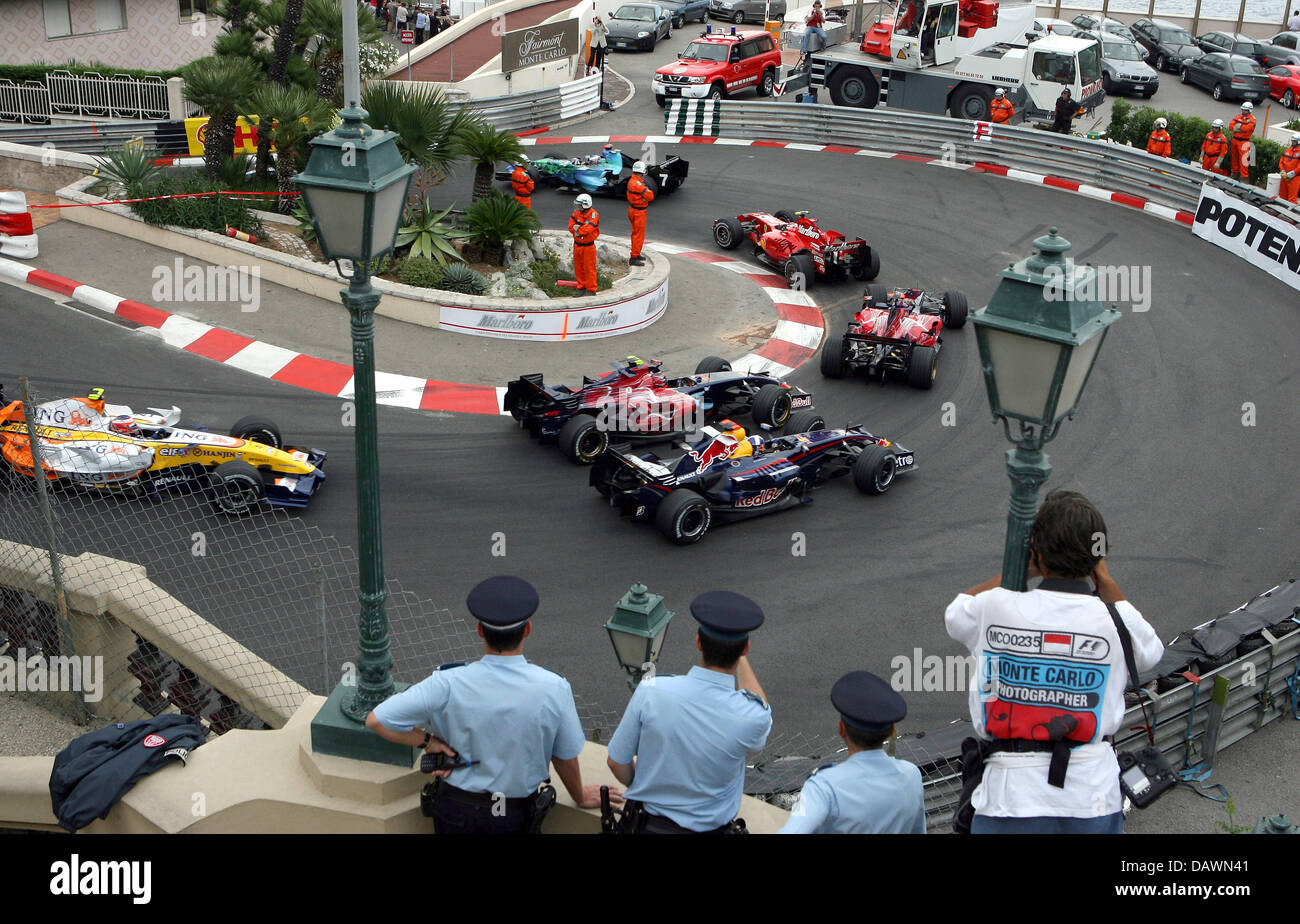 Several Race Cars Steer Through A Hairpin Curve During The Grand