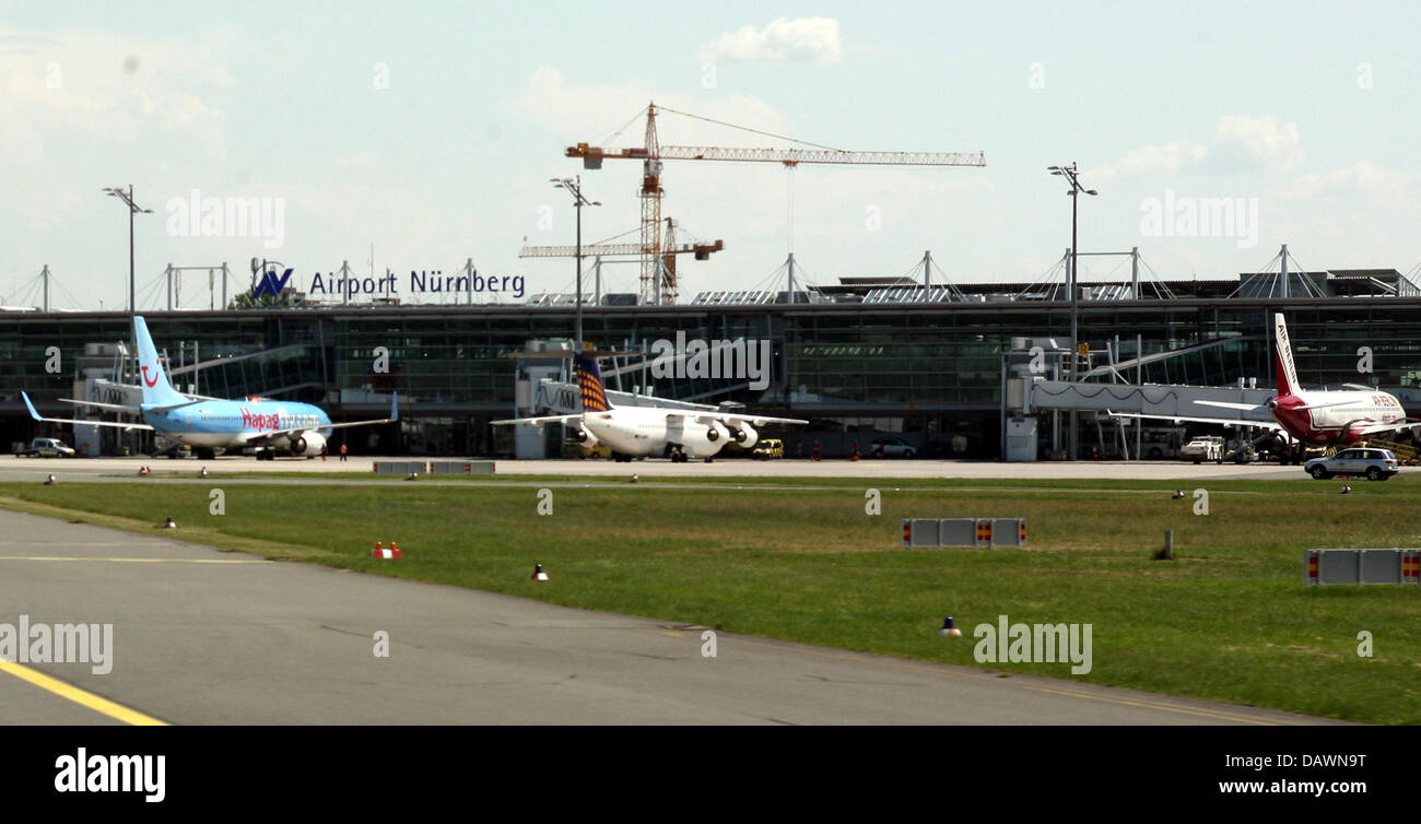 Three airplanes shown from behind at their gates at Nuremberg airport, Germany, 22 May 2007