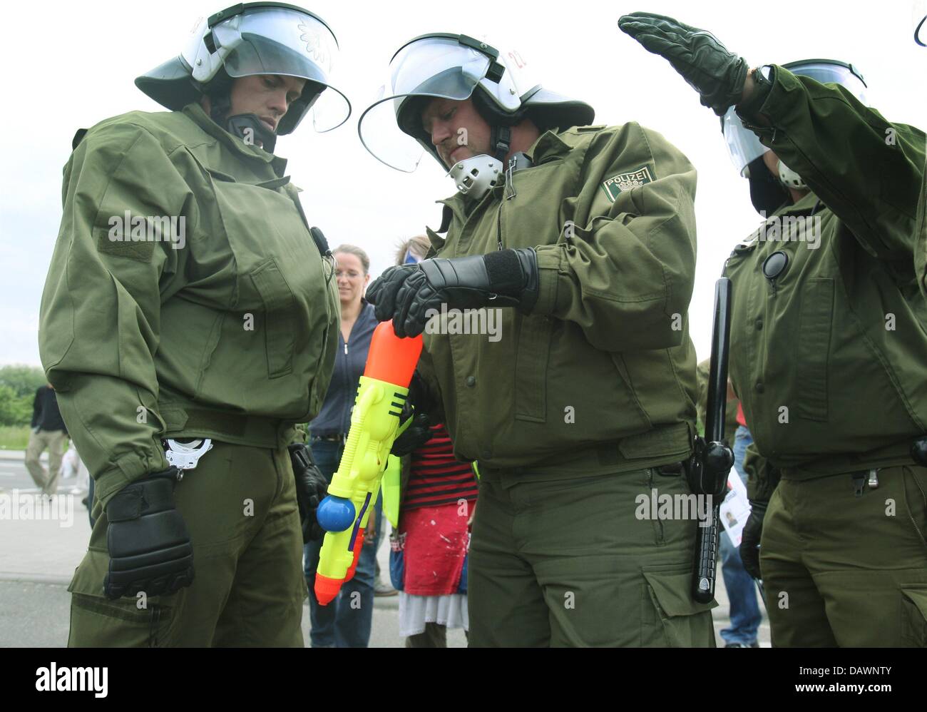 Riot Police Personnel Check The Tank Of A Water Pistol During A Rally On  The Occasion Of 'Migration Day' In Rostock, Germany, 4 June 2007. The G8  Summit Will Take Place In