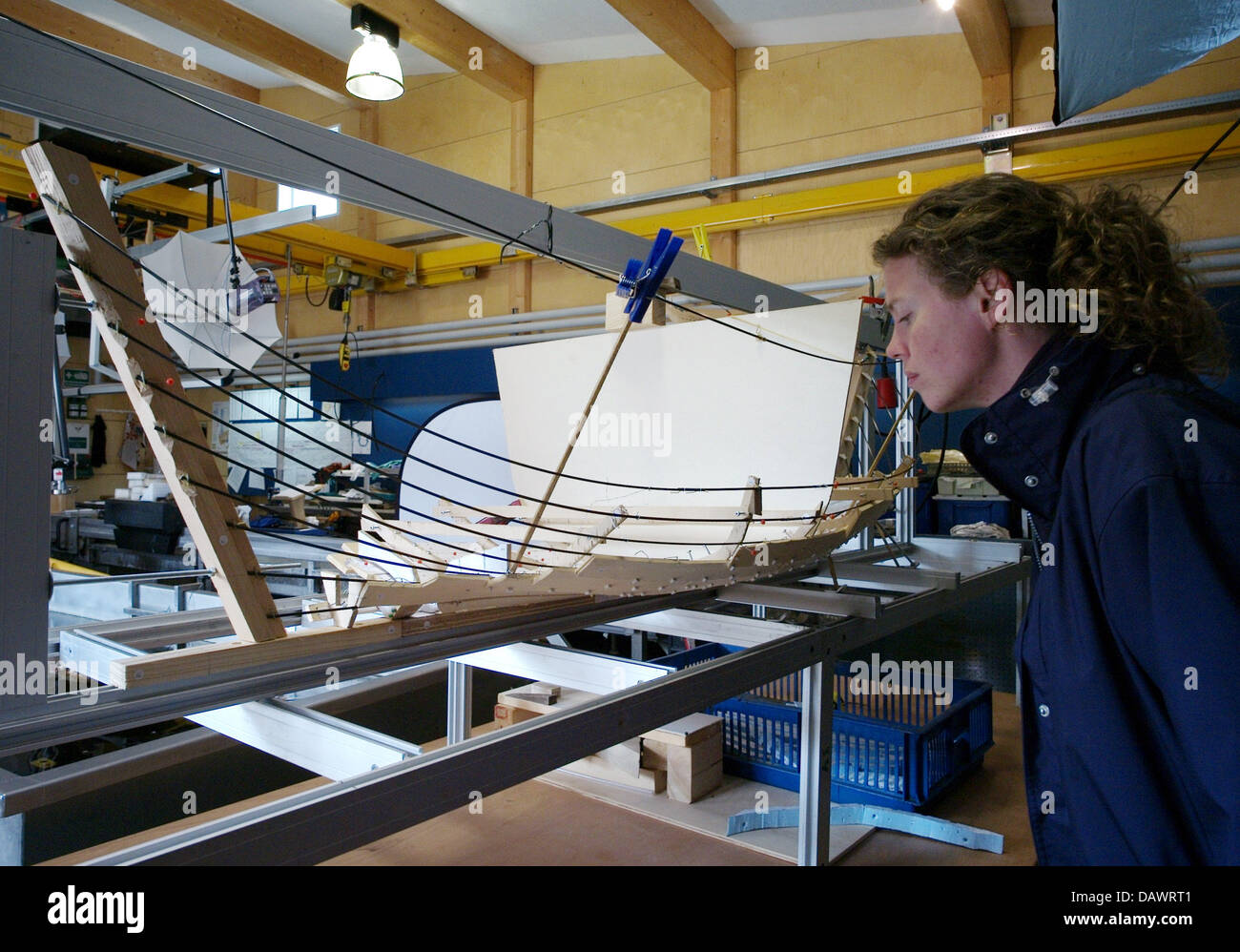 A visitor takes a look at a model of a Viking ship in the archeological workshop of the museum for Viking ships in Roskilde, Denmark, 22 May 2007. The model represents the most ambitious Viking ship project in the world. The long boat Skuldelev 2, a Viking warship with 30 metres length, is currently being reconstructed with tools from the Viking age. On 01 July 2007 it is going to Stock Photo