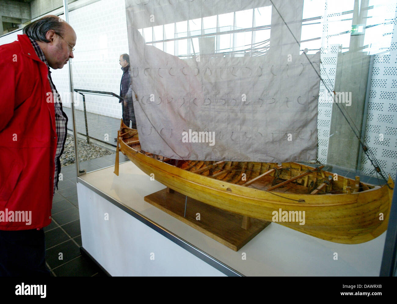 A visitor takes a look at a model of a Viking ship of the 11th century, discoverd in the Roskilde fjord in 1962, in the ship hall of the museum for Viking ships in Roskilde, Denmark, 22 May 2007. Shipbuilding and seafaring of the Vikings are presented in the museum that has its own wharf and an archaeological workshop and offers Viking ship boat trips in the summer. Photo: Maurizio Stock Photo