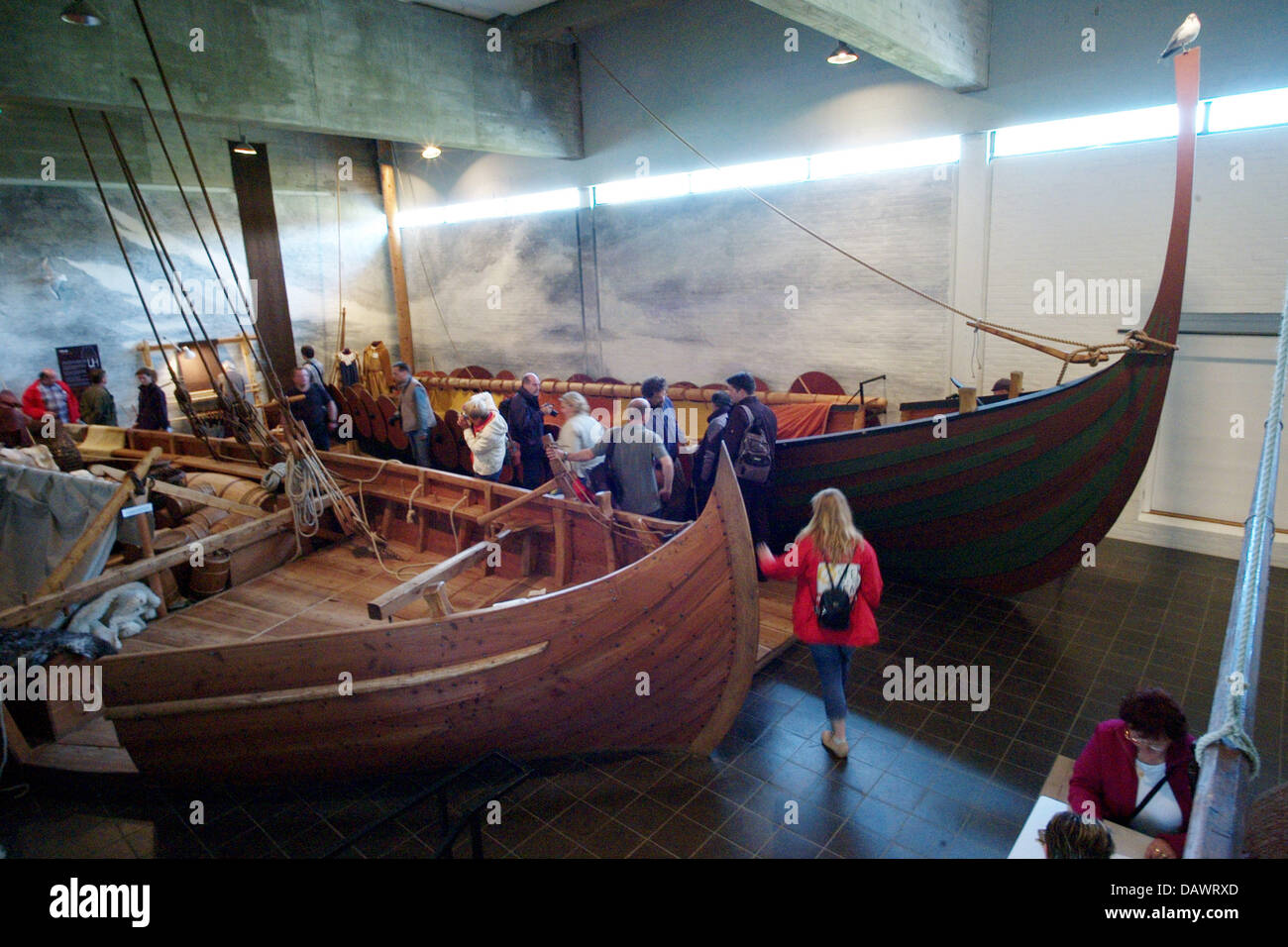 Visitors take a look at reconstructed Viking ships from the 11th century, discoverd in the Roskilde fjord in 1962, in the ship hall of the museum for Viking ships in Roskilde, Denmark, 22 May 2007. Shipbuilding and seafaring of the Vikings are presented in the museum that has its own wharf and an archaeological workshop and offers Viking ship boat trips in the summer. Photo: Mauriz Stock Photo