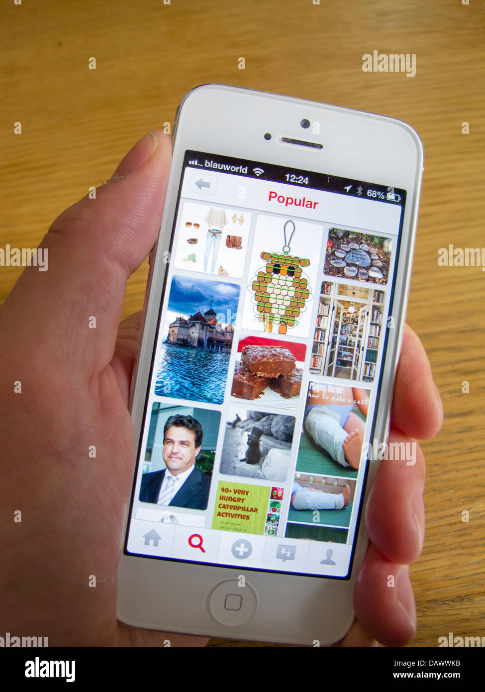 Pinterest homepage on white iPhone 5 smartphone Stock Photo