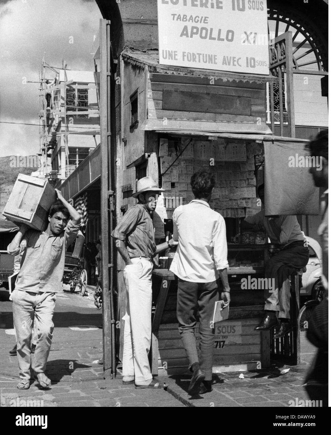 geography / travel, Mauritius, Port Louis, street scene, lottery booth in a shopping street, 1960s, 60s, 20th century, historic, historical, store, stores, shop, shops, trade, dealer, dealers, street scene, street scenes, pedestrian, pedestrians, passer-by, passerby, passers-by, old town, historic city centre, historic city center, inner city, midtown, city centre, town centre, urban core, lottery, lotteries, do the lottery, game of chance, games of chance, stall, huckster, hucksters, street vendor, lottery tickets, batch, people, Additional-Rights-Clearences-Not Available Stock Photo