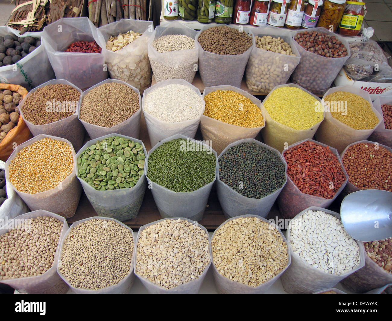 Bags full of different legumes are offered for sale at the old market