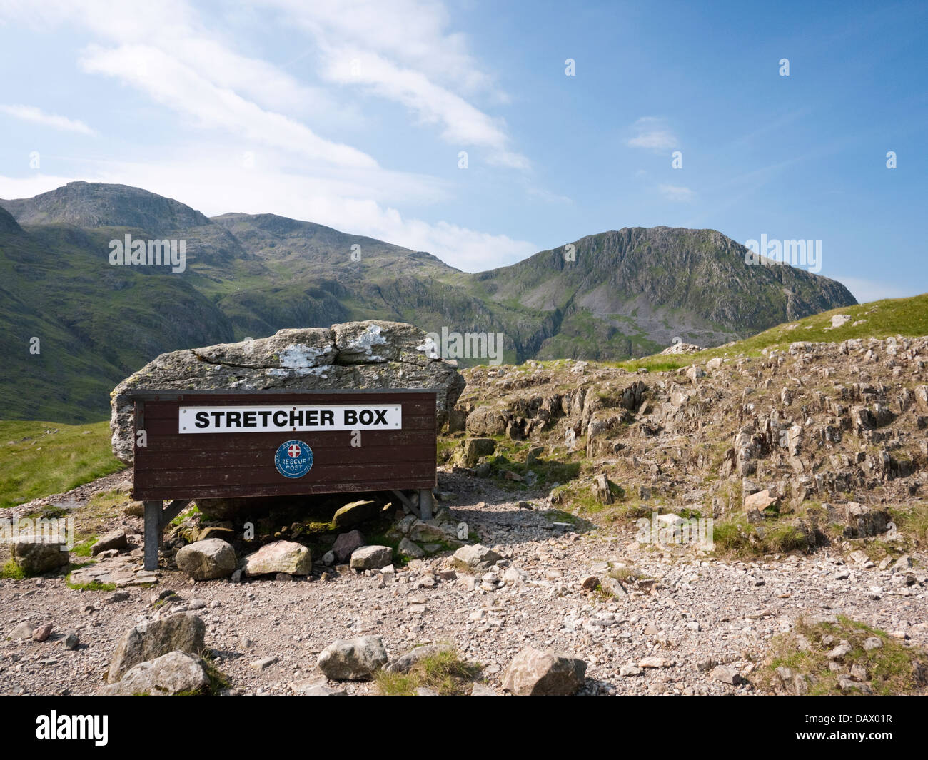 Mountain Rescue stretcher box at Sty Head, overlooked by Scafell Pike and Lingmell in The Lake District, Cumbria Stock Photo