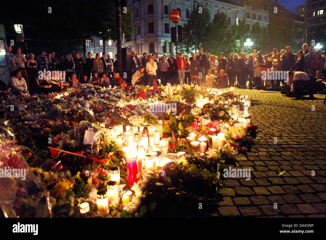 People charing their grief with candles and flowers outside cathedral ...