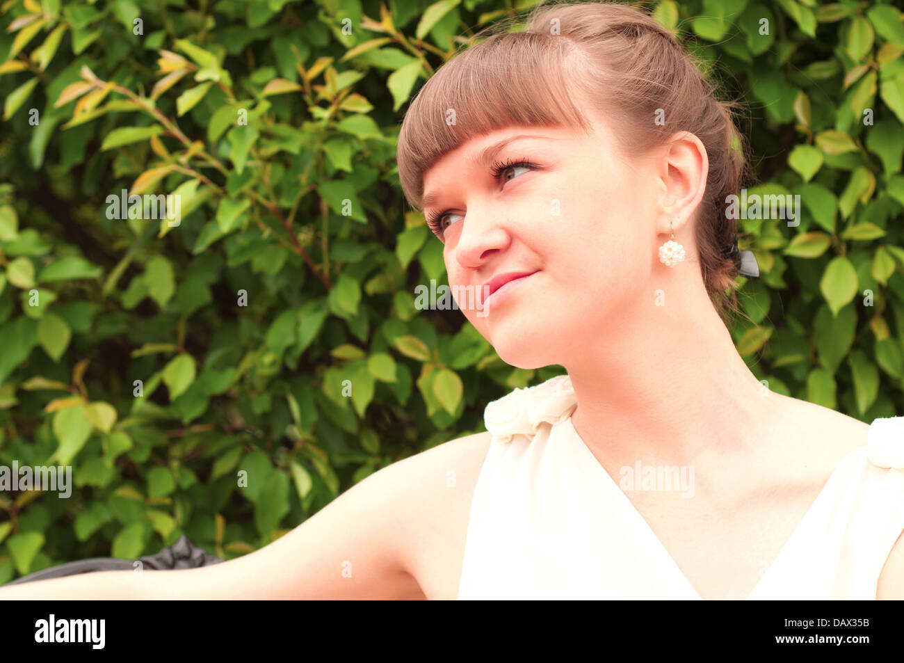 A beautiful woman is sitting on a park bench Stock Photo - Alamy