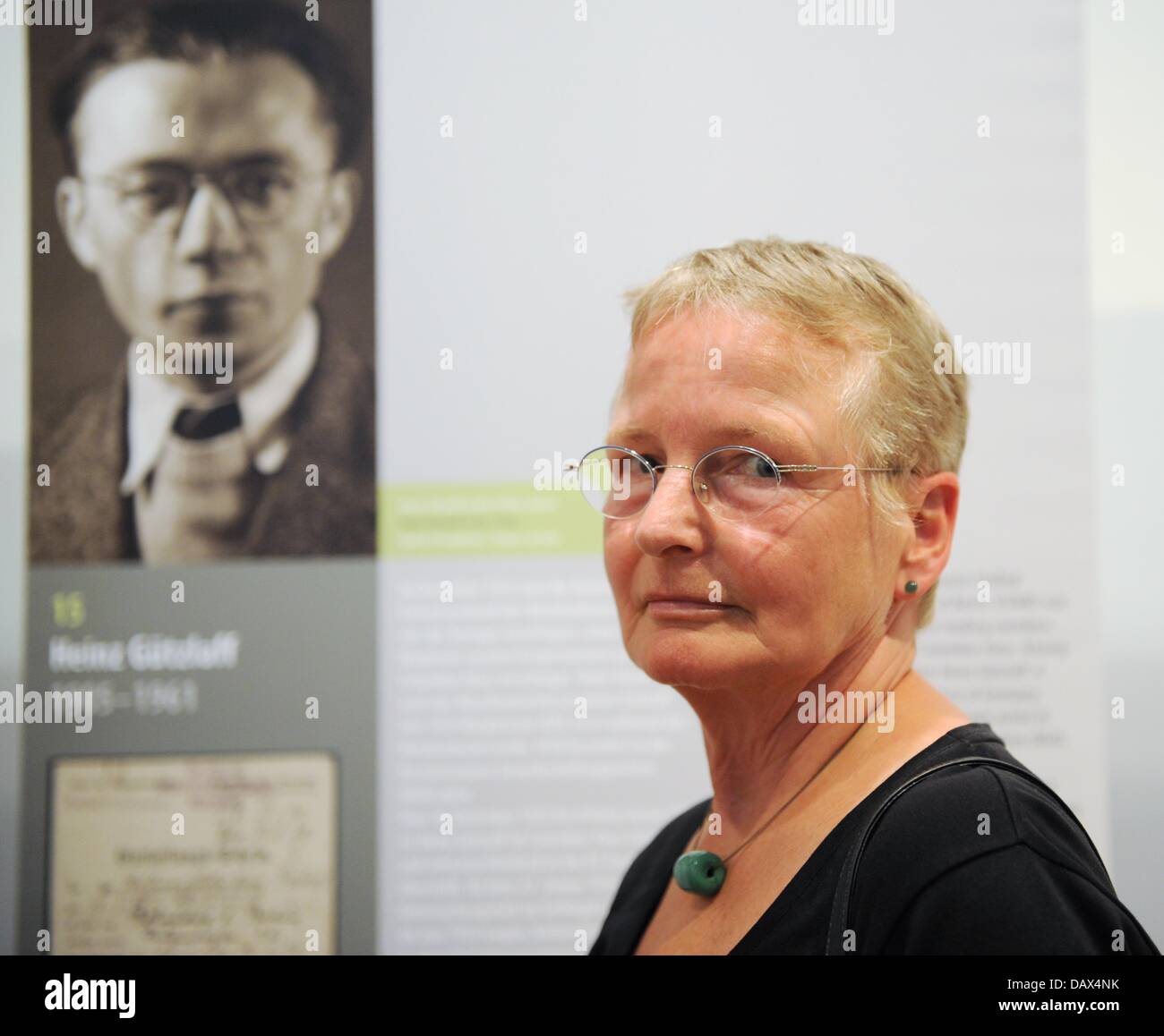 Kathrin Reiher stands in front of a poster portraying her father in the exhibition 'Warum schweigt die Welt - Häftlinge im Berliner KZ Columbiahaus' ('Why does the world keep silent - prisoners in the Berlin concentration camp Columbiahaus') at the Memorial to the German Resistance in Berlin, Germany, 19 July 2013. The exhibition is about the Berlin concentration camp Columbia. Photo: OLE SPATA Stock Photo
