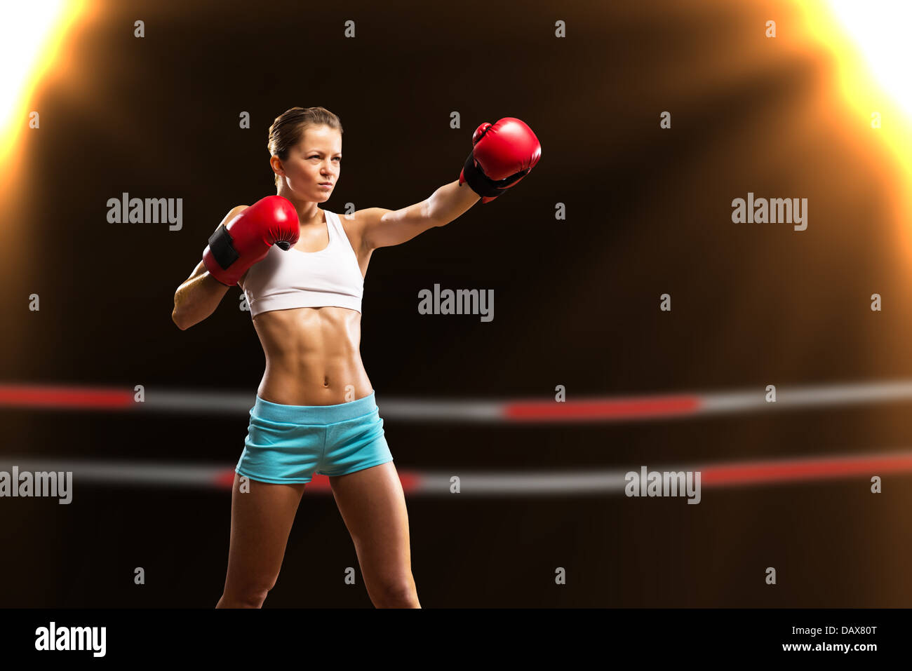 Portrait of confident young woman wearing red boxing gloves and black  sports bra Stock Photo - Alamy