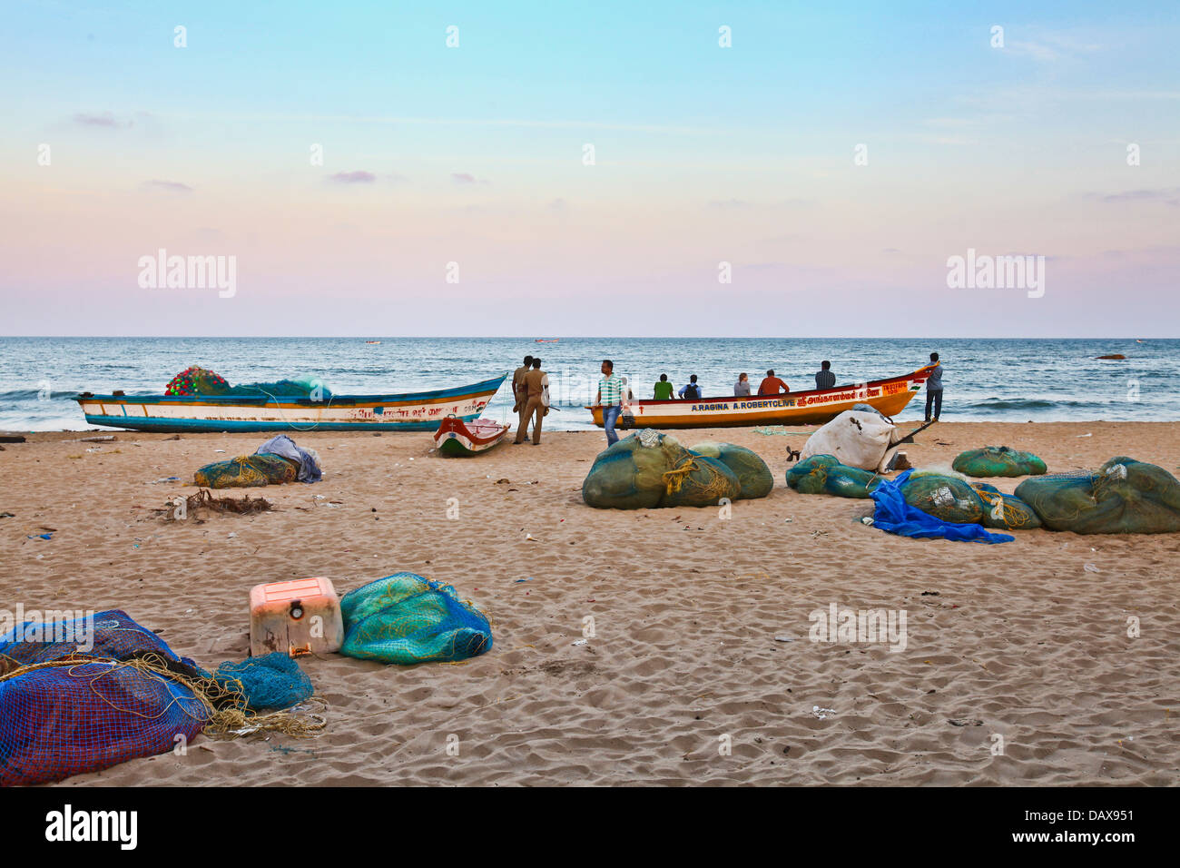 Fishermen sort out their fishing nets on the beach in Mahabalipuram, in the southern Indian