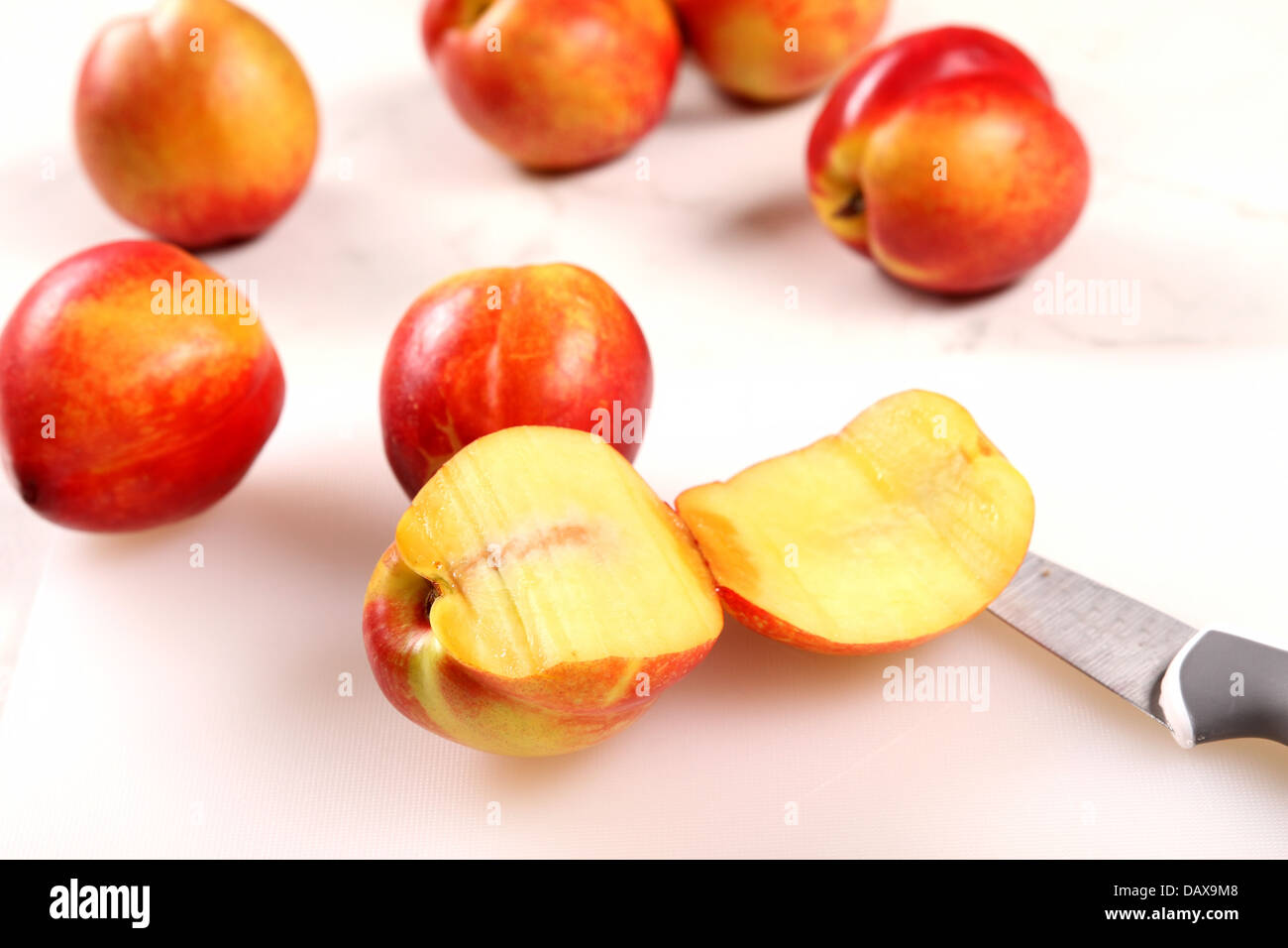 Cutting Nectarines on the kitchen table Stock Photo Alamy