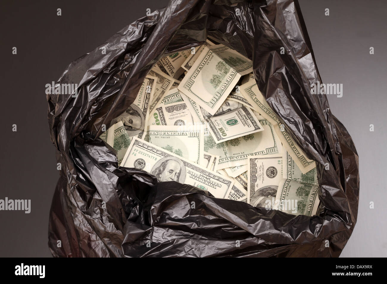A Rubbish bag full of dollars Stock Photo Alamy