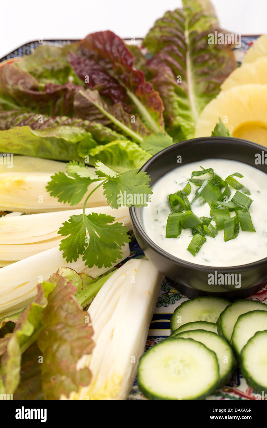 Asian food with sauce, cucumber, pineapples and salad. Stock Photo