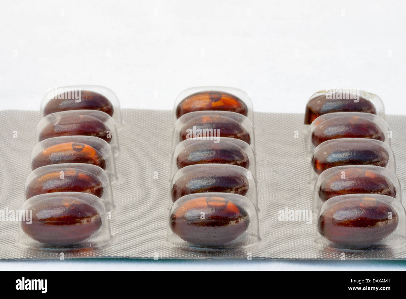 Blister of brown gelatinous capsules against white Stock Photo Alamy