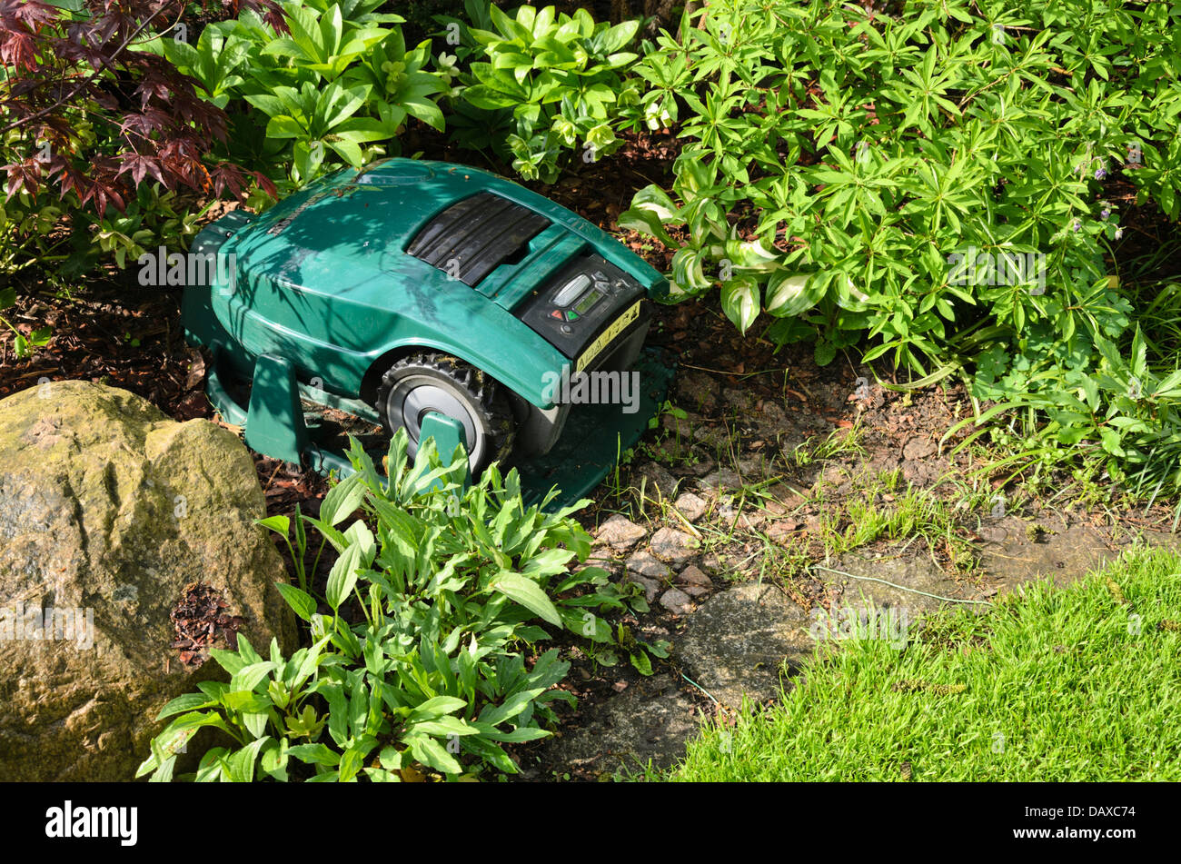 Robot lawn mower with charging station Stock Photo