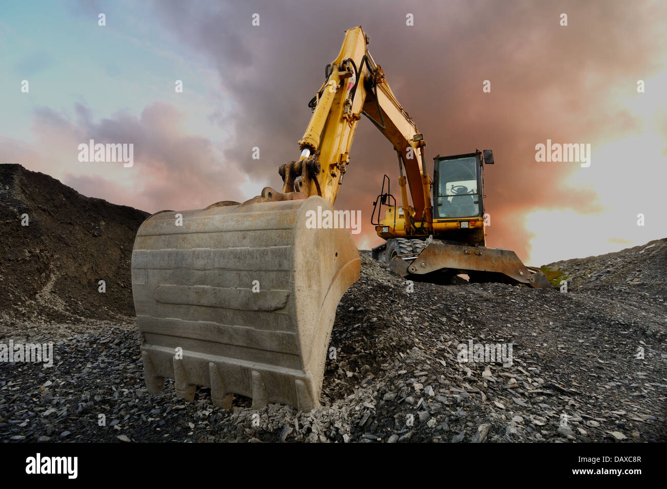 Image of a wheeled excavator on a quarry spoil heap Stock Photo