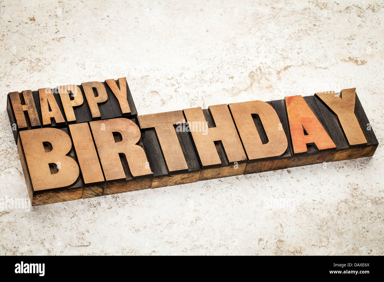 happy birthday text in vintage letterpress wood type on a ceramic tile background Stock Photo