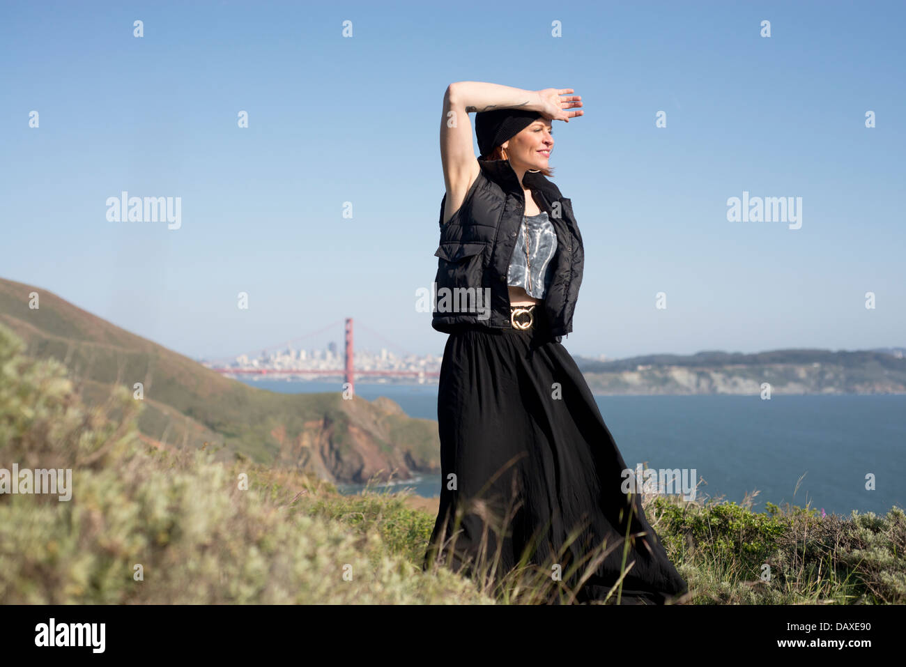 Mature attractive woman posing with Golden Gate Bridge in the background Stock Photo