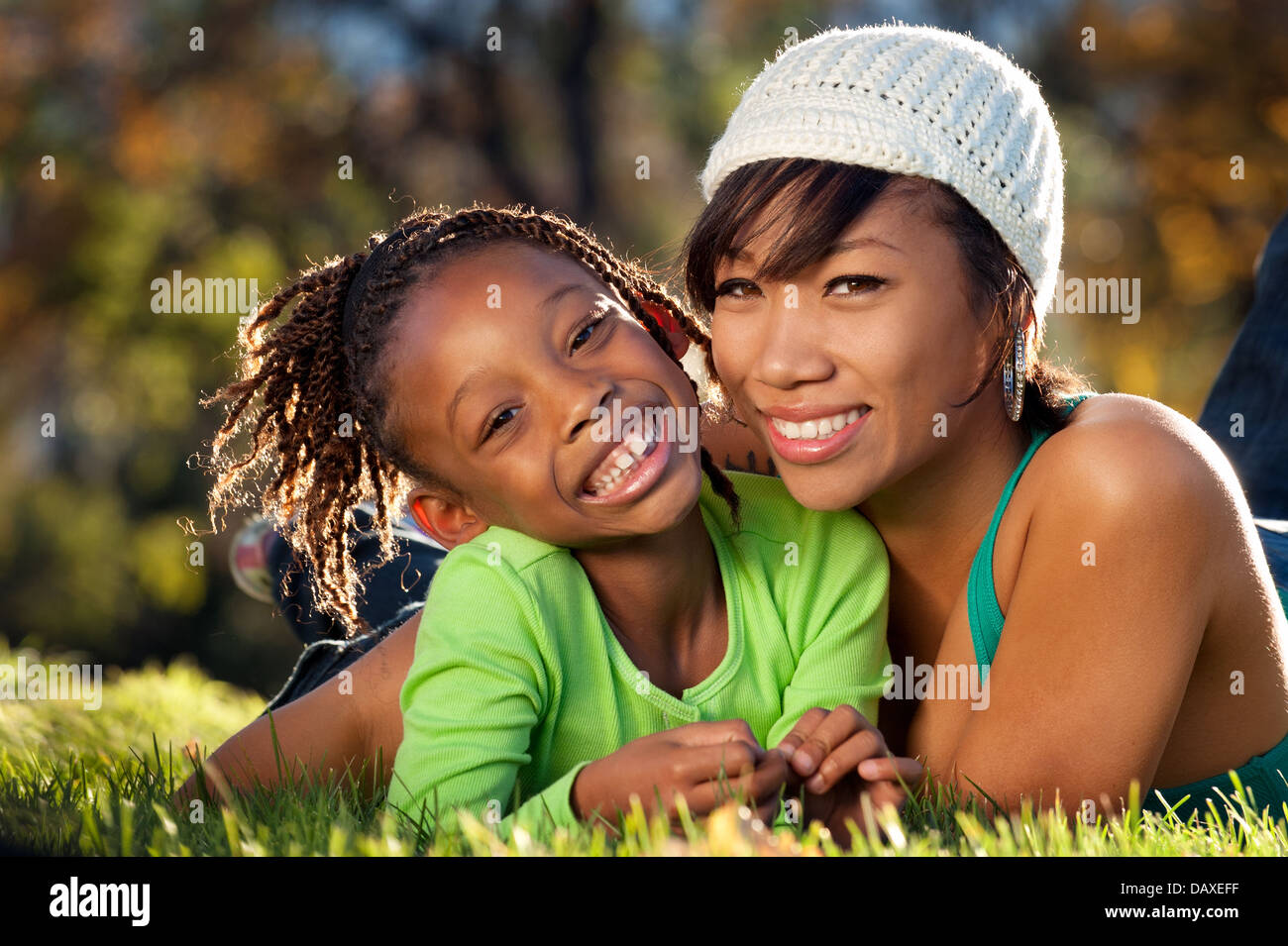Happy child enjoying spending time in a park with her mother Stock Photo