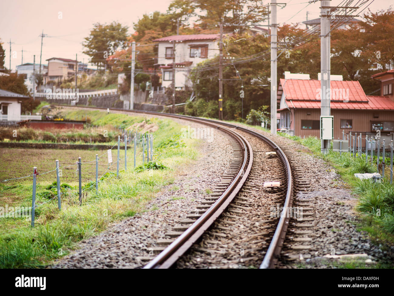 Train tracks run through a rural Japanese neighborhood in Fujiyoshida, Japan. Stock Photo