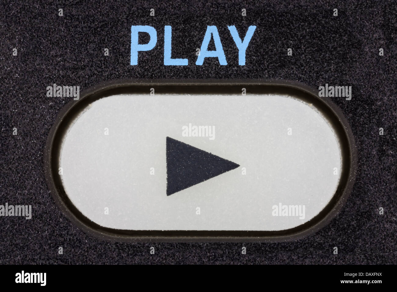 Remote control device play button macro detail. Stock Photo