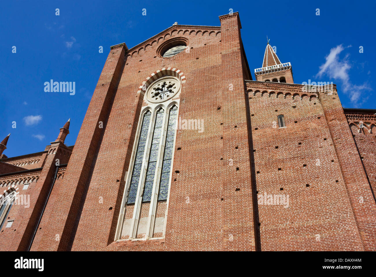 Red brick facade of the Dominican church of Sant'Anastasia in Verona, Italy in a bright sunny day, over a blue sky. Stock Photo