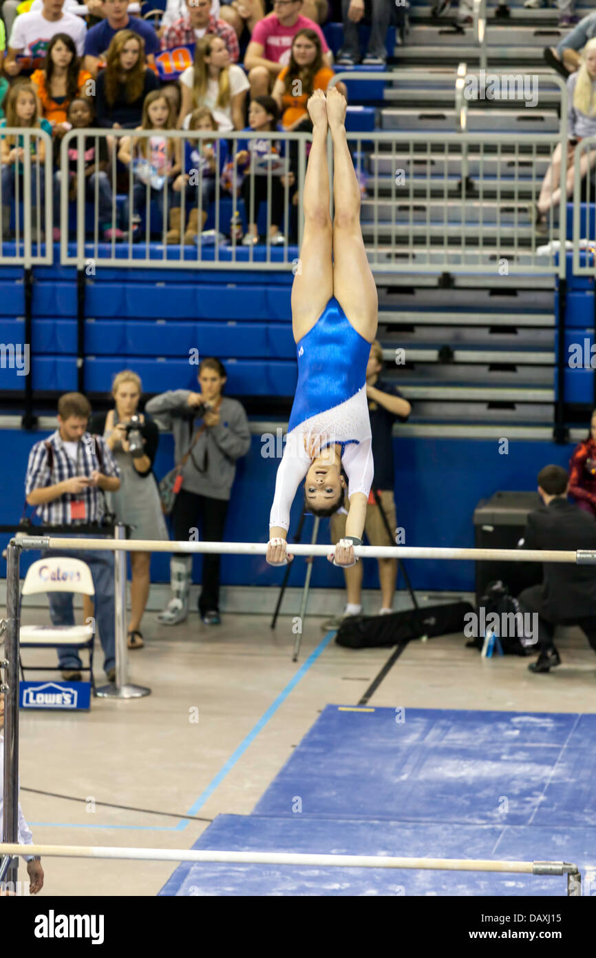 Woman competes on uneven parallel bars during Alabama Crimson Tide