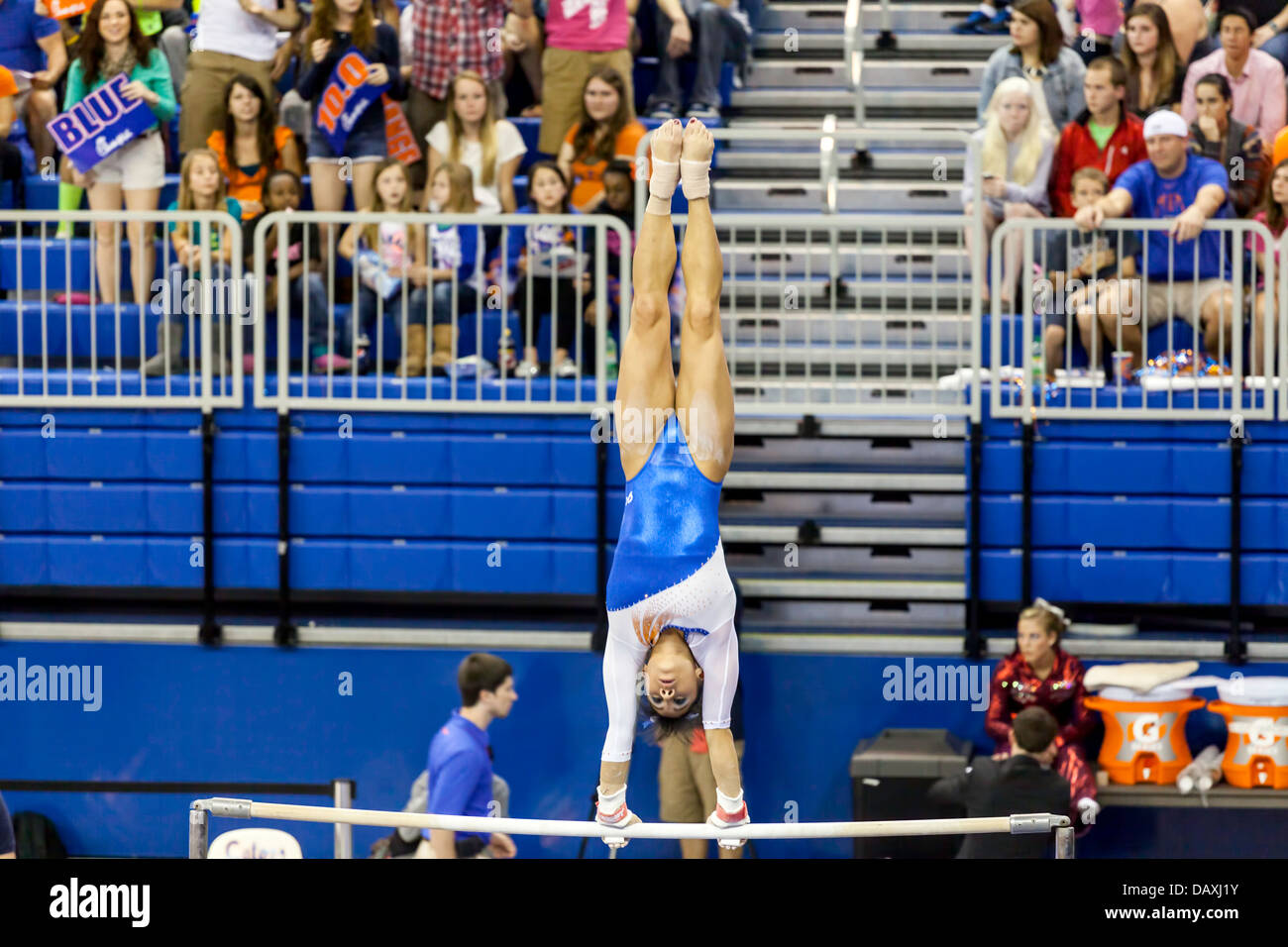 Woman competes on uneven parallel bars during Alabama Crimson Tide