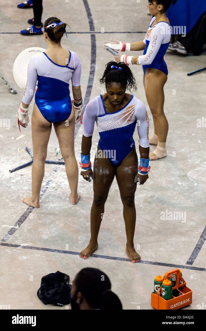 Alabama Crimson Tide women's gymnastics Woman competitors on uneven parallel bars during Alabama Crimson Tide  versus UF Gators Women's Gymnastics Meet (2-8-13 Stock Photo - Alamy
