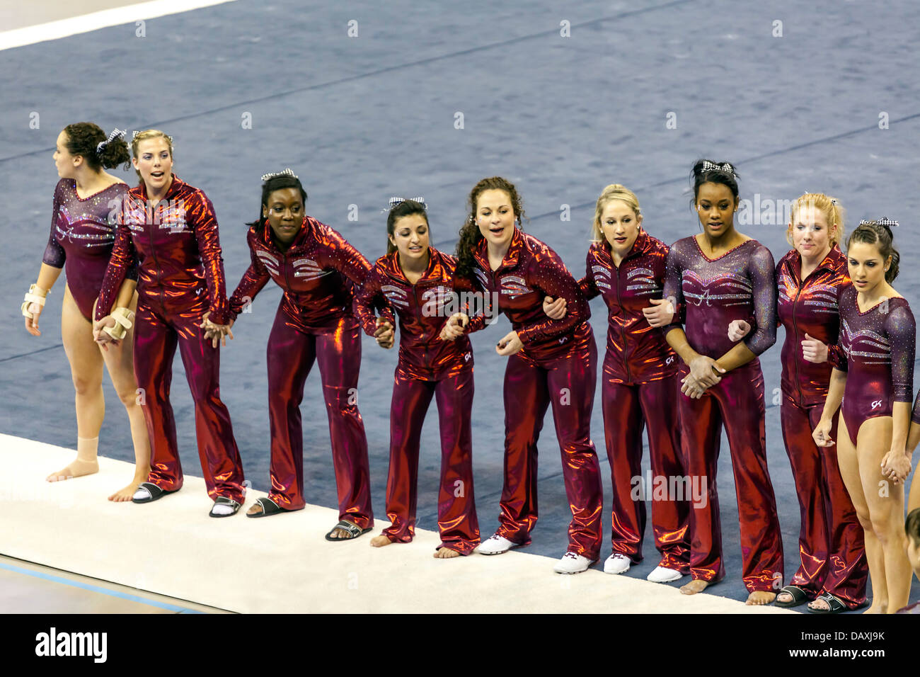 Alabama Crimson Tide women's gymnastics team cheer on fellow vaulting competitor during meet with University of Florida (2-8-13) Stock Photo