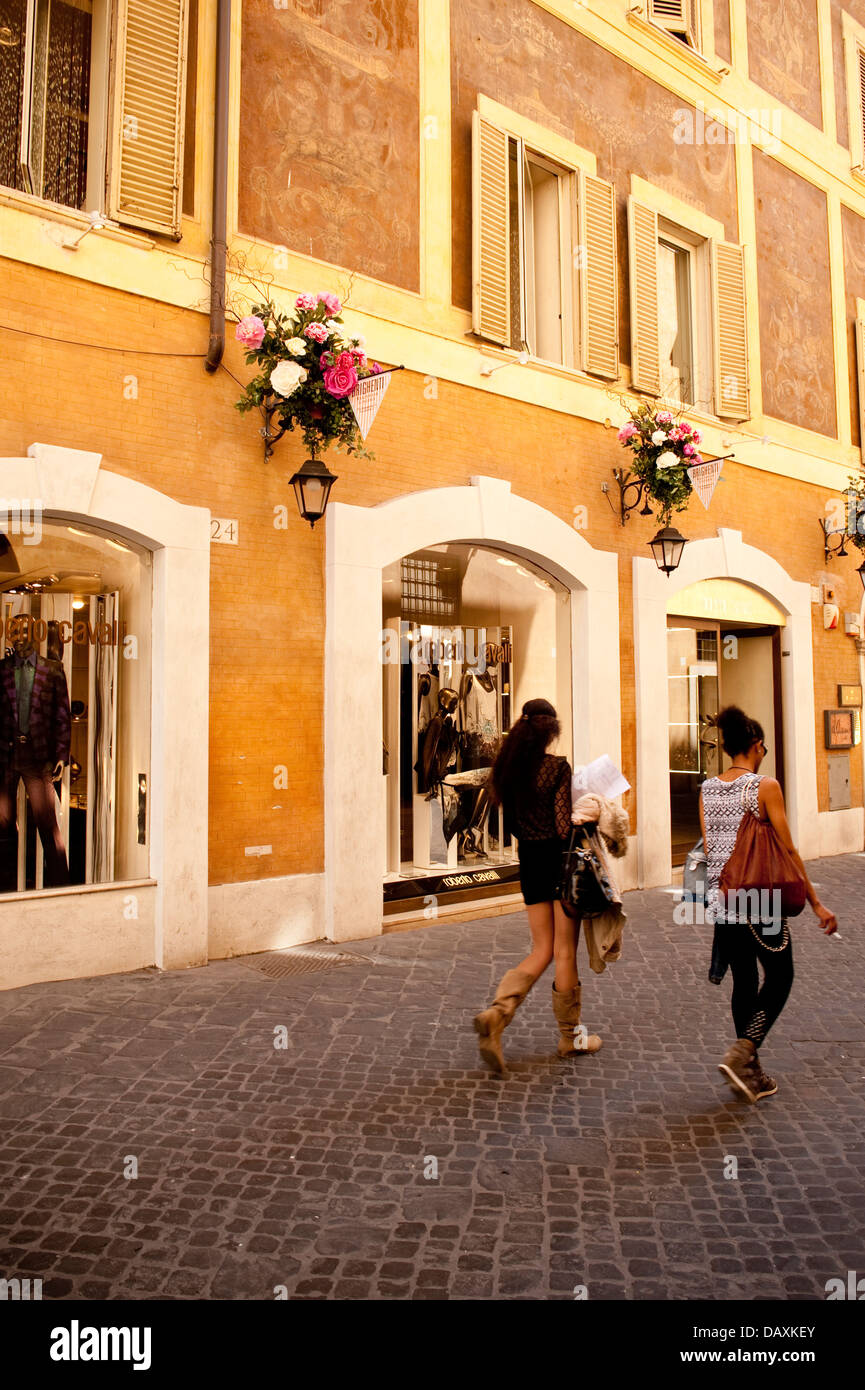 Two women walking down a street in the shopping district of Rome, Italy Stock Photo