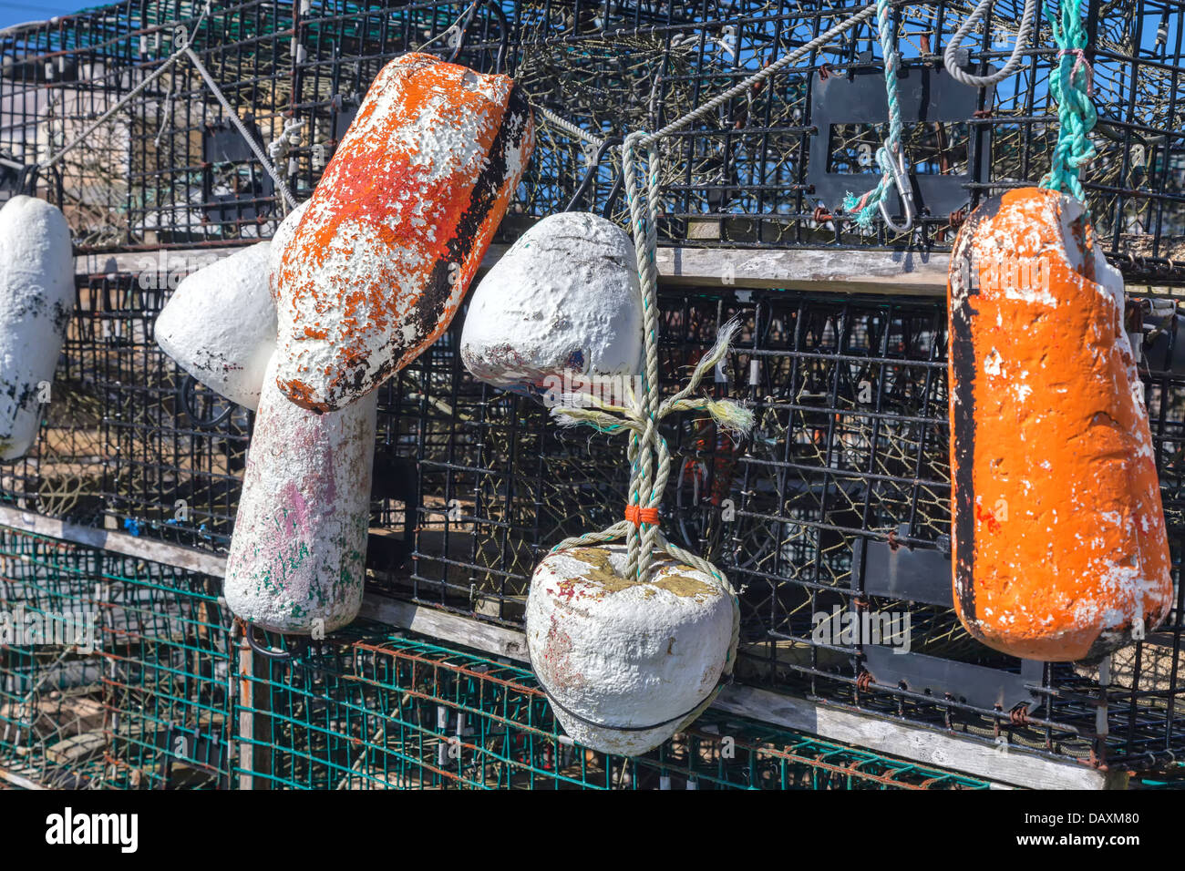 Weathered buoys and traditional lobster traps on the wharf. Stock Photo