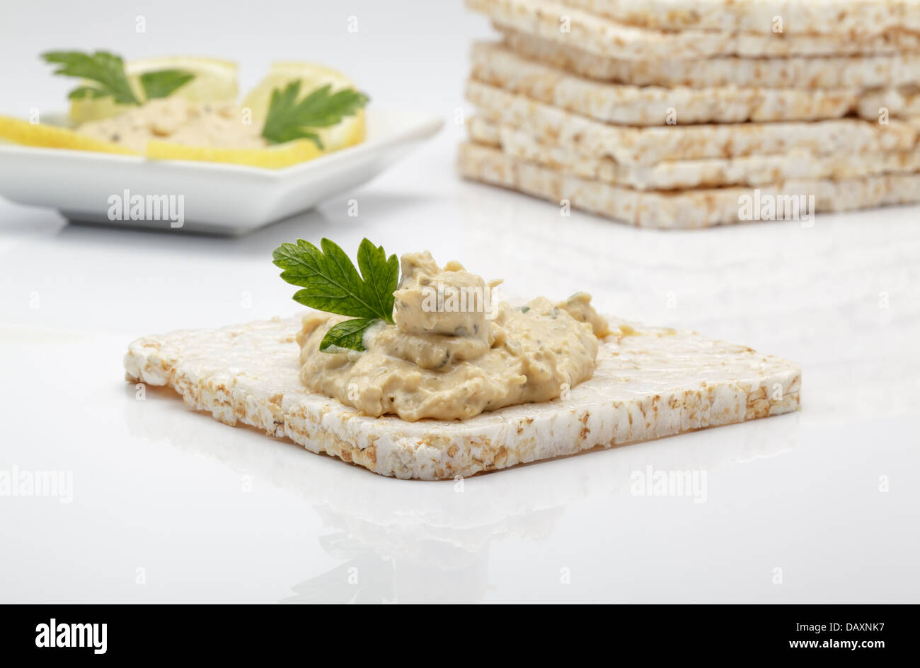 Square ricecakes with lemon and coriander houmous Stock Photo Alamy