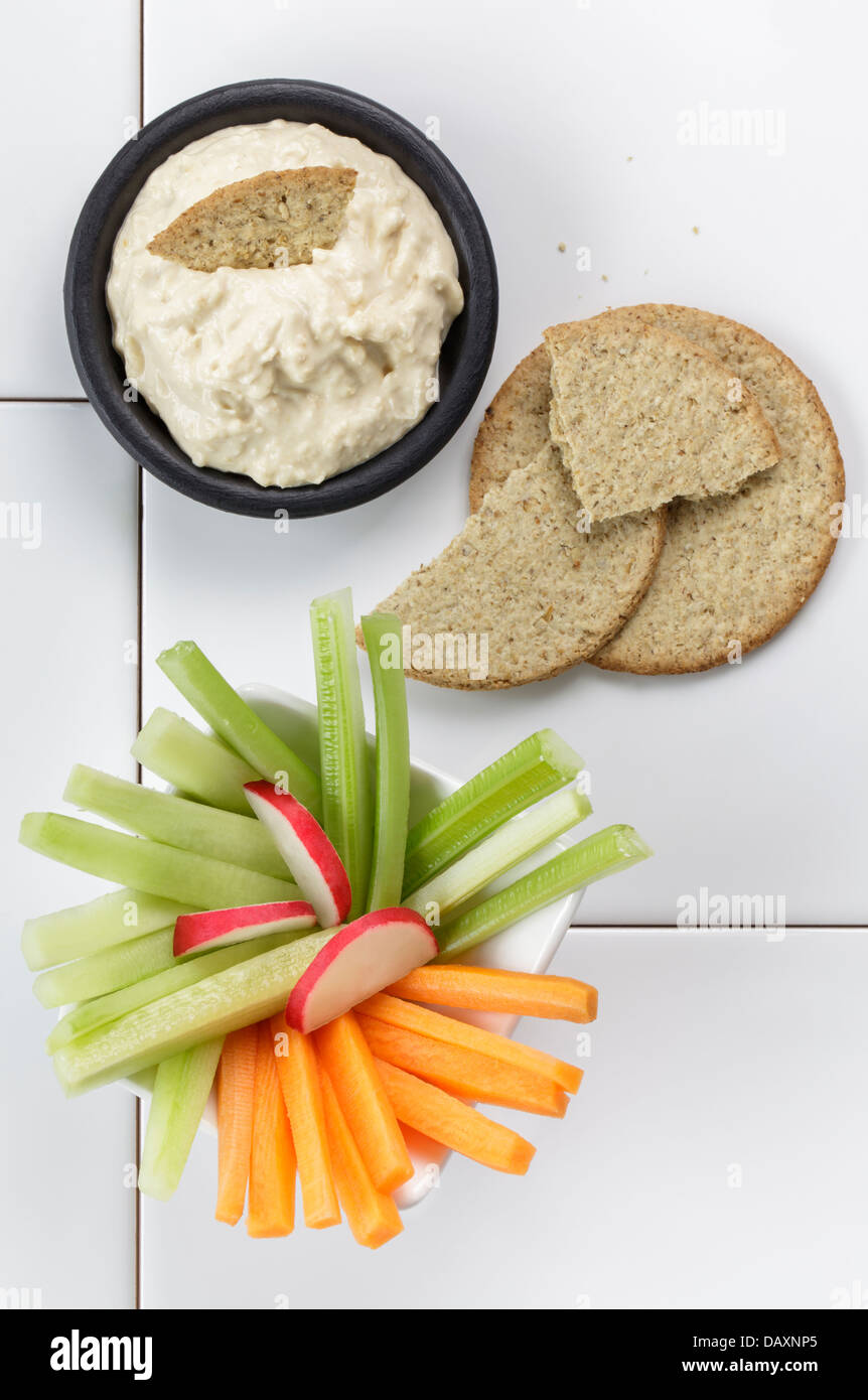 Houmous with fresh vegetables and oatcakes Stock Photo