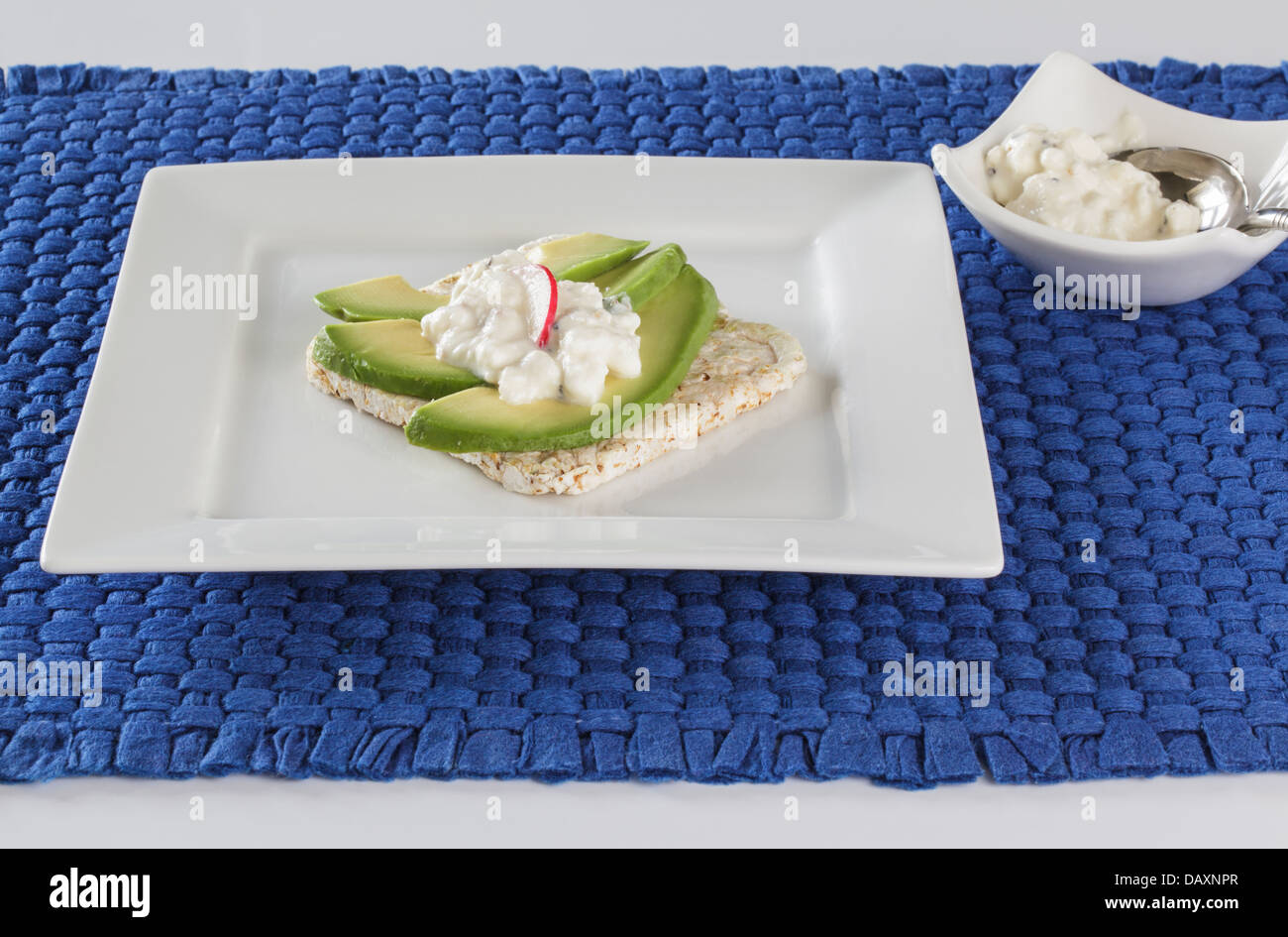 Rice cake topped with avocado and cottage cheese Stock Photo