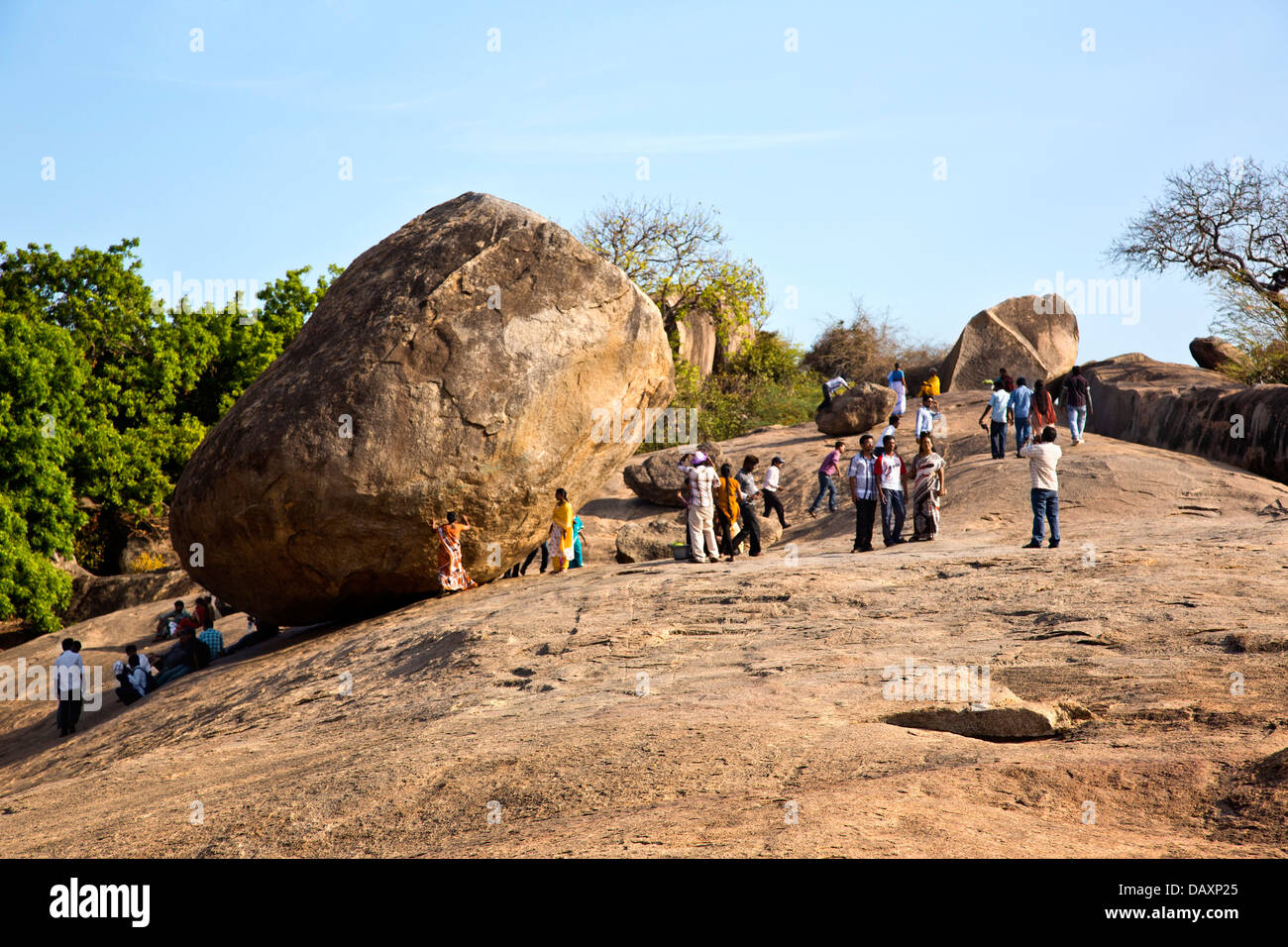 Tourists near a rock on a hill, Krishna's Butter Ball, Mahabalipuram, Kanchipuram District, Tamil Nadu, India Stock Photo
