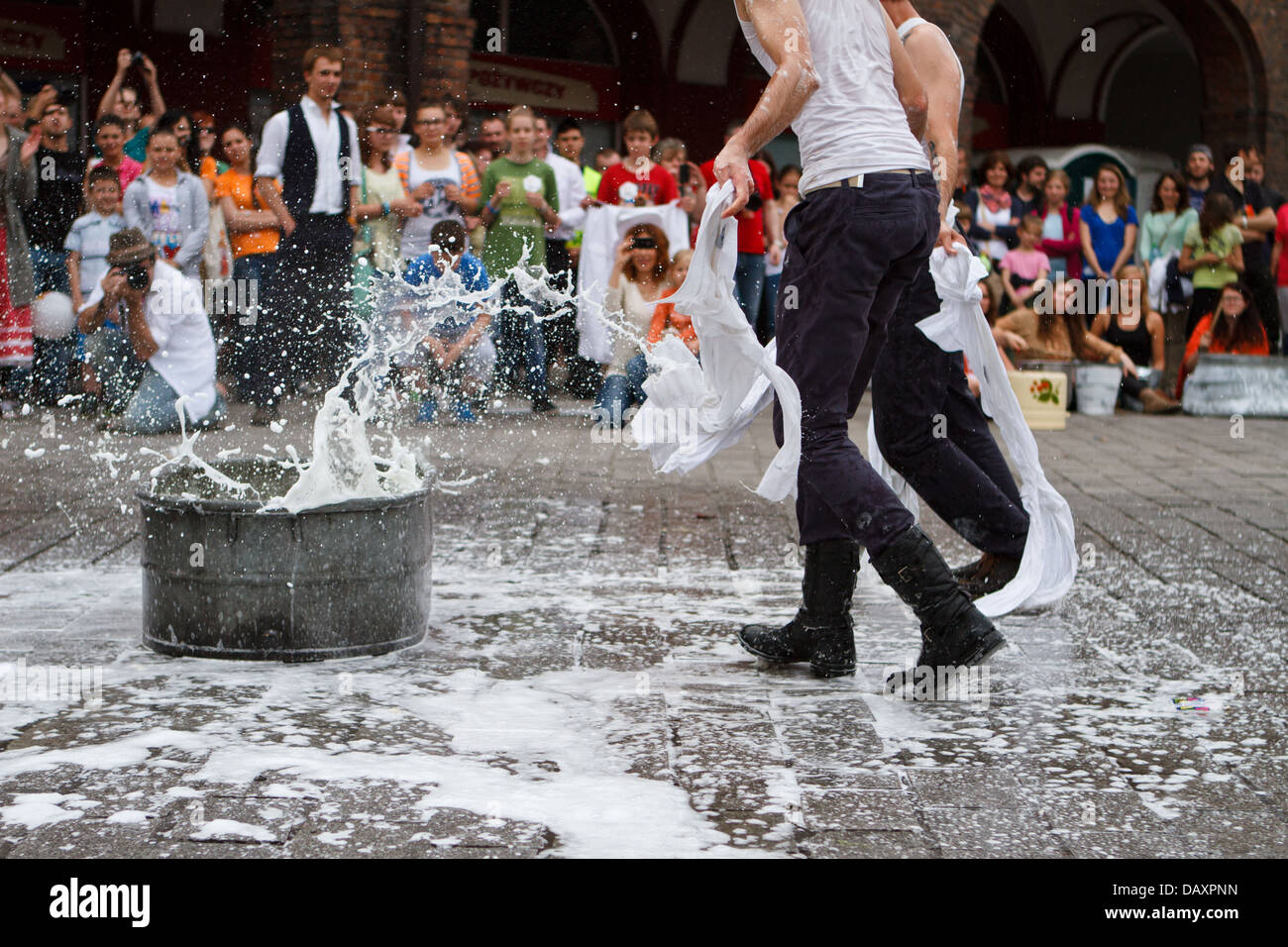 A street performance with foam and bath tub during 'Industriada' 2013 at Nikiszowiec main square. Katowice, Poland. Stock Photo