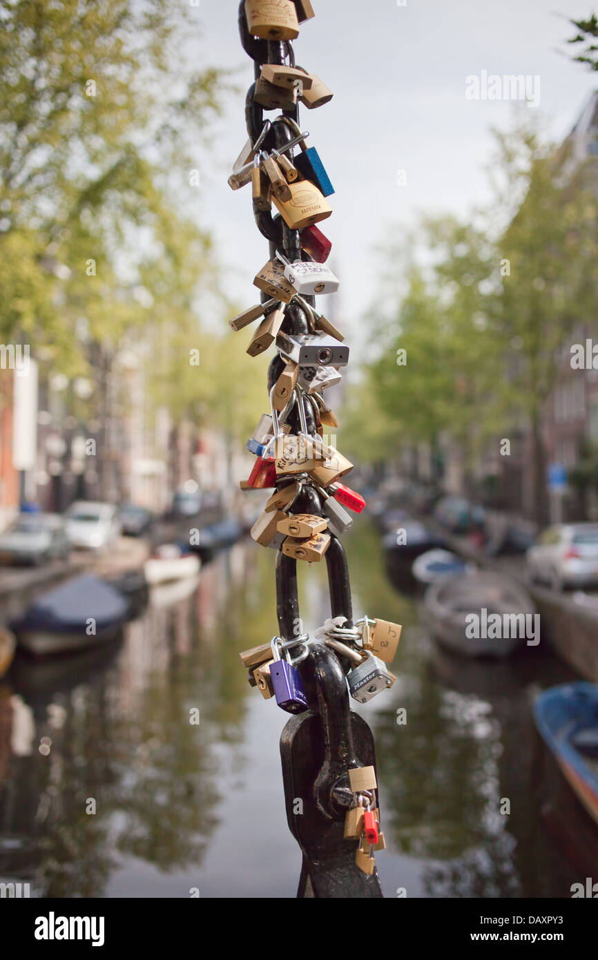 Love locks on a drawbridge of Groenburgwal canal in Amsterdam, Netherlands. Stock Photo