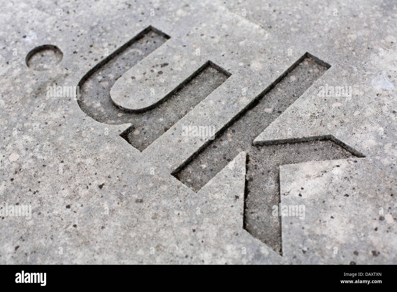 close-up of the '.uk' internet country code for the UK carved into stone. Stock Photo