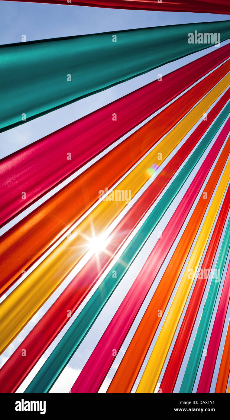 Sunlight flares through richly coloured ribbons. Stock Photo