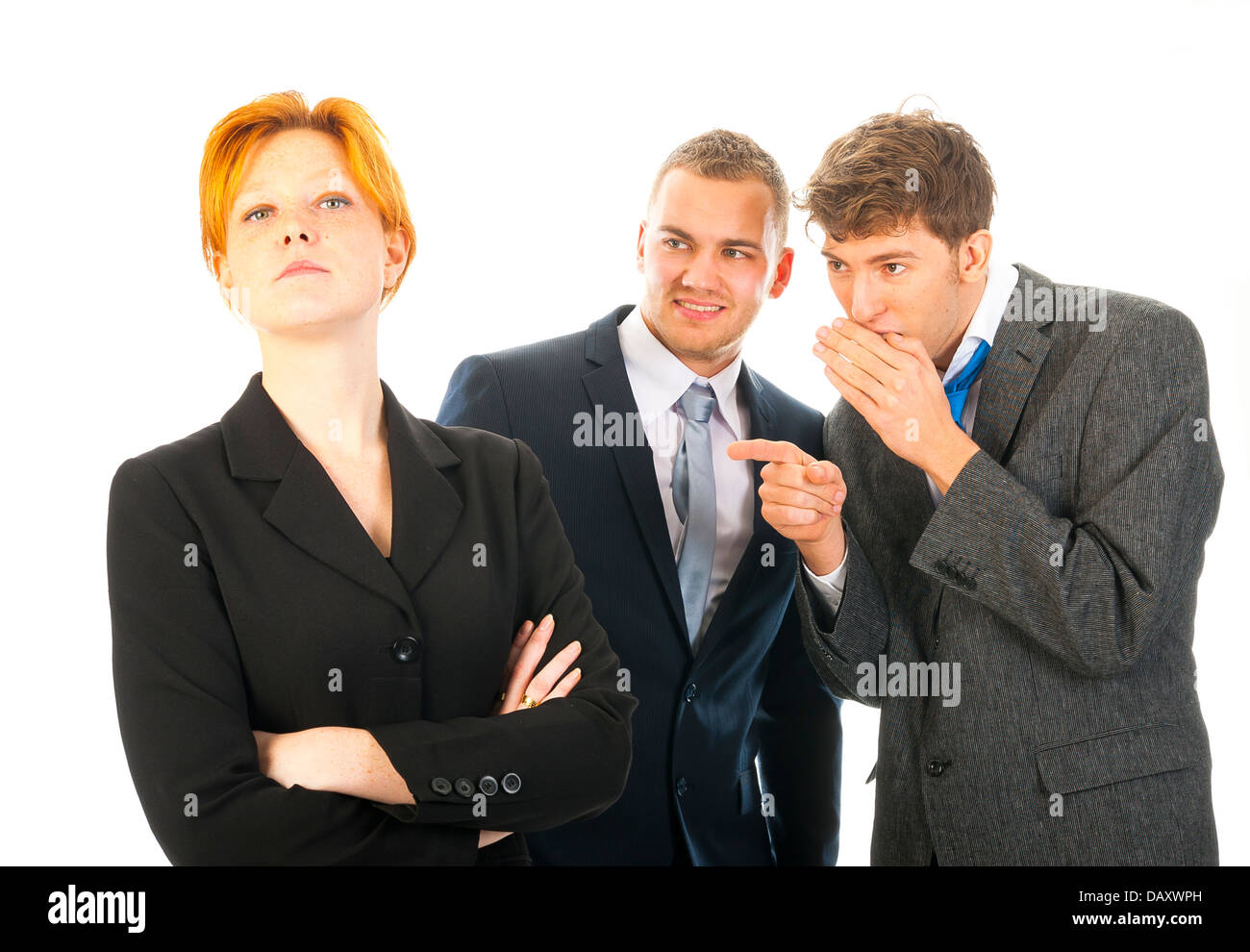 two men are whispering behind the back of a colleague Stock Photo